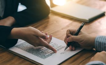 Signing the agreement in the contract.